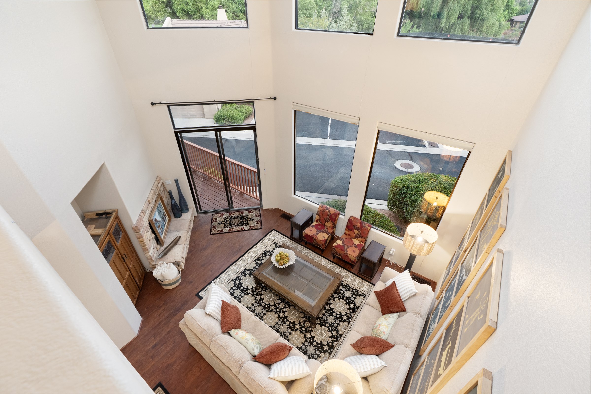 The freshly furnished double-height great room and its hillside view