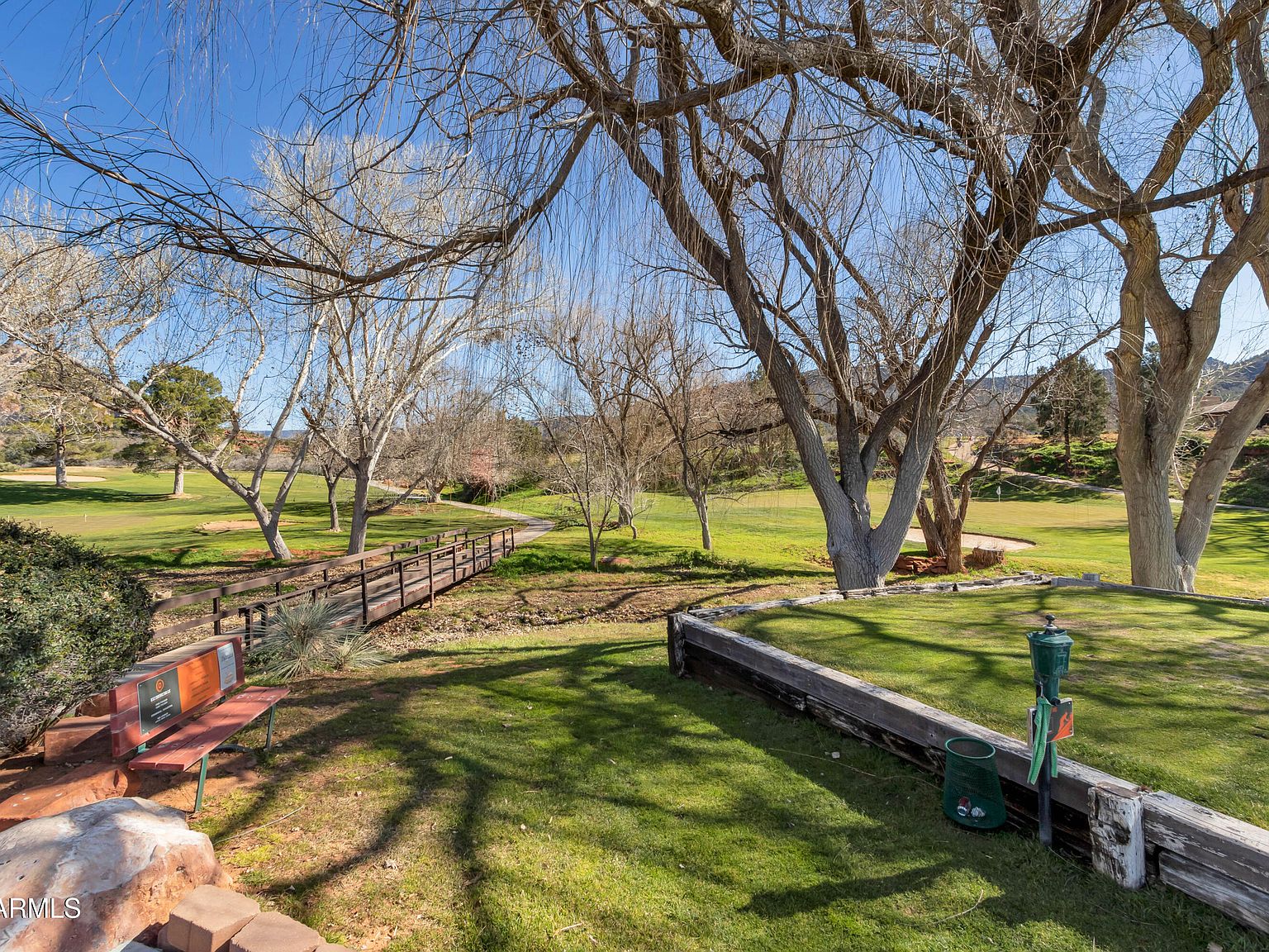A footbridge and tree-lined grounds at Canyon Mesa