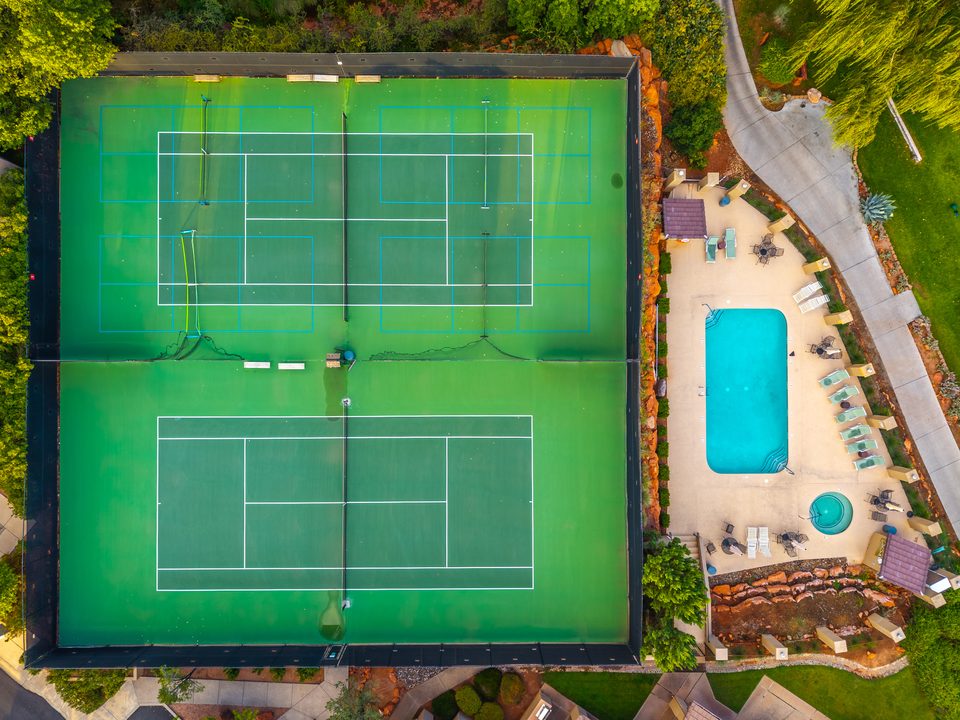An overhead view of the community pool and tennis courts
