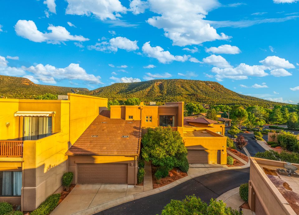 The front of the home in warm evening light · Aerial photograph