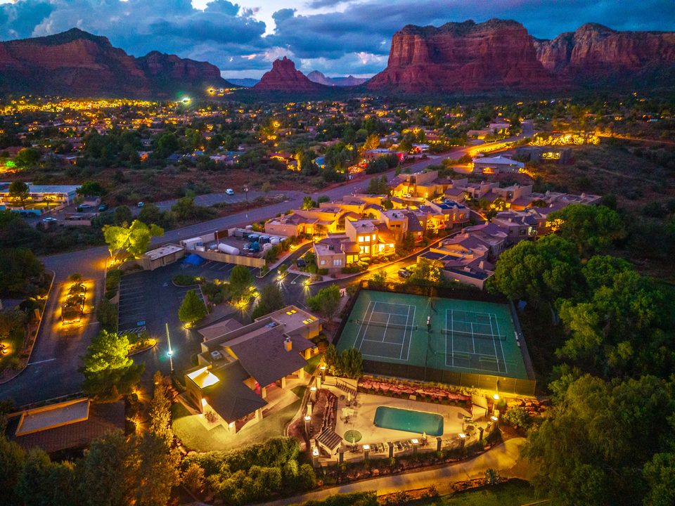 The pool, courts, and surrounding neighborhood at twilight