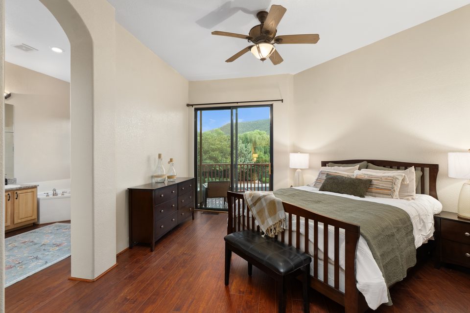 Bedroom with balcony access and hillside views