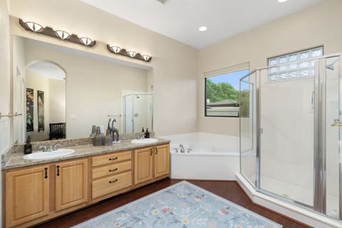The ensuite bath with dual vanity, soaking tub, and shower